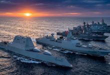 Seven powerful modern naval destroyers sailing in formation during sunset in 2026.