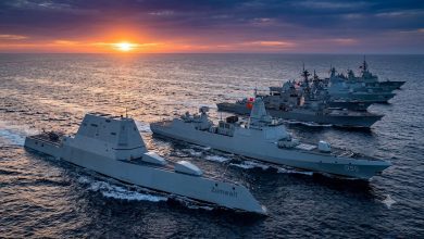 Seven powerful modern naval destroyers sailing in formation during sunset in 2026.